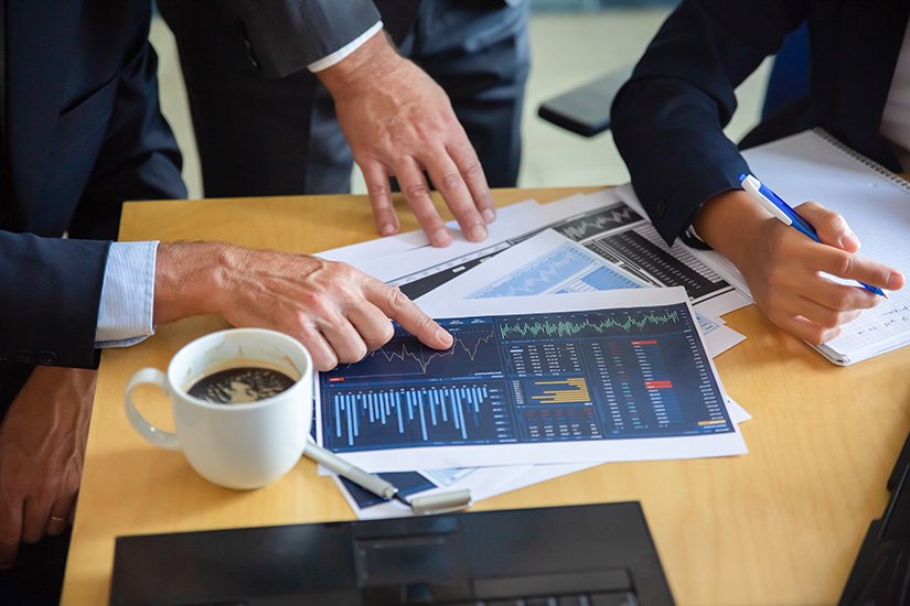 Unrecognizable businessman pointing at printed chart